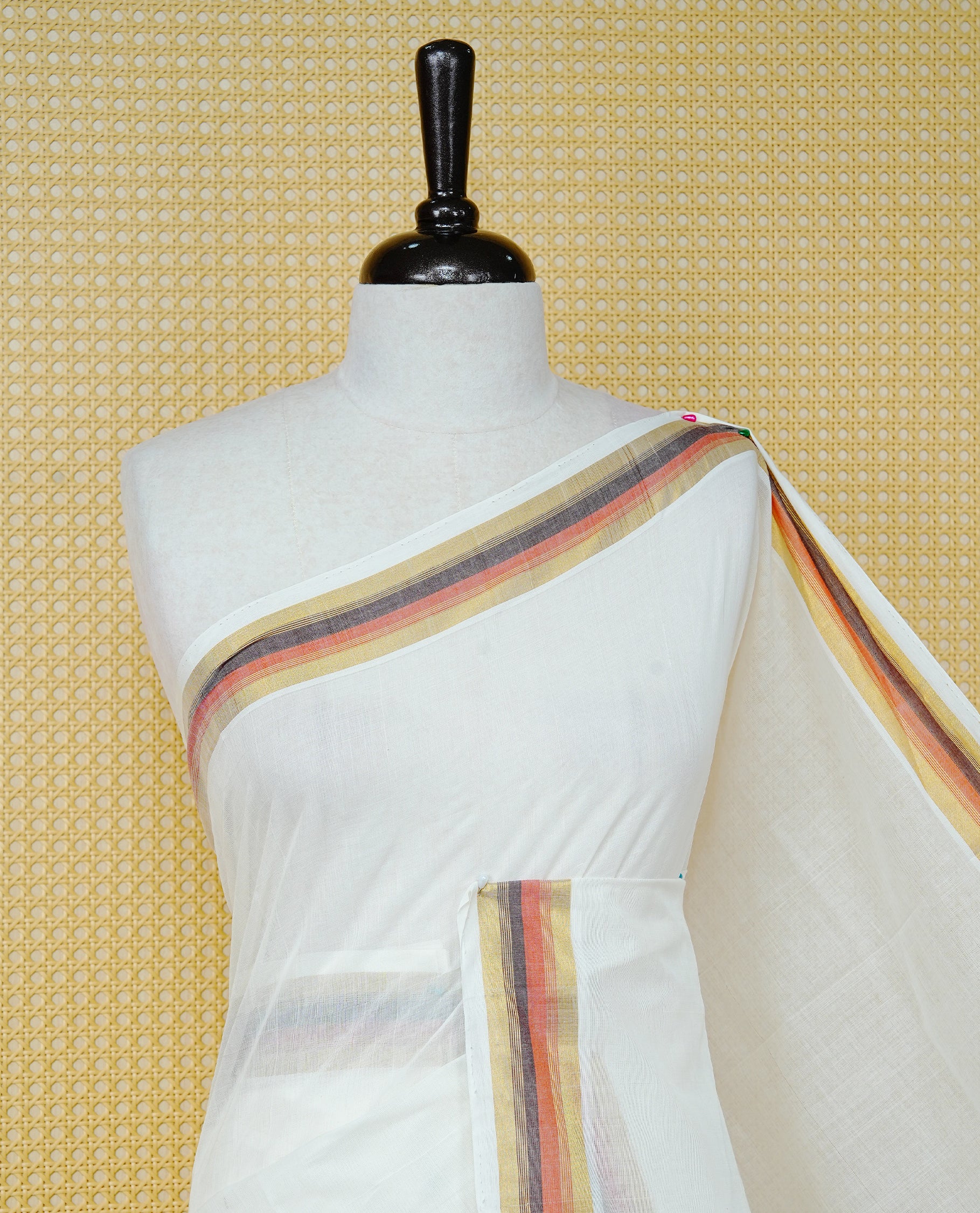 Cream colour Cotton kerala saree featuring Classy Plain body, complemented by Gold with Brown  & Orange zari border & Pallu, paired with matching blouse piece.
