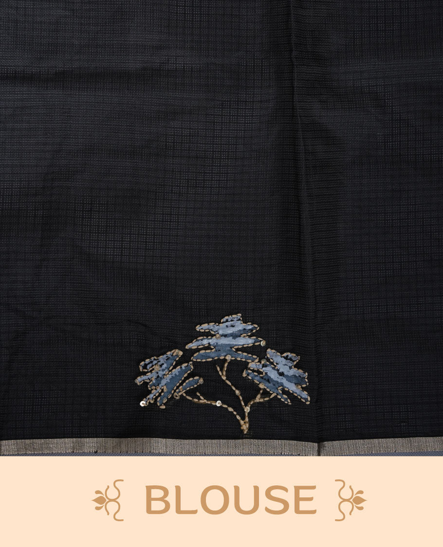 Black colour semi tusser silk saree featuring refined floral embroidery across the body, enhanced with gentle contrast border detailing and accompanied by a perfectly matching embroidered blouse.