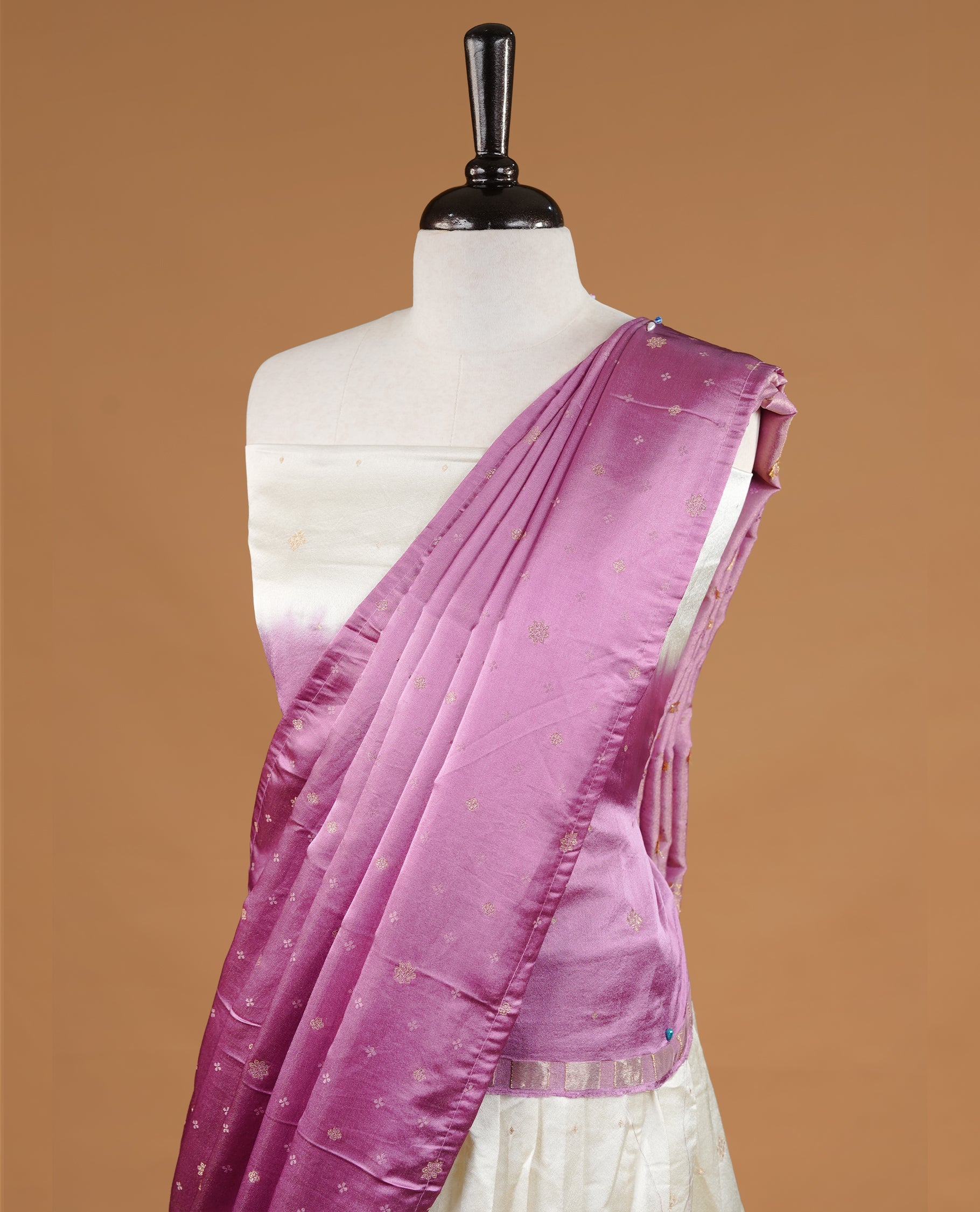 Off White colour half saree material featuring delicate zari buttas on the blouse and skirt, paired with a contrast Pink zari border and matching small zari motifs dupatta
