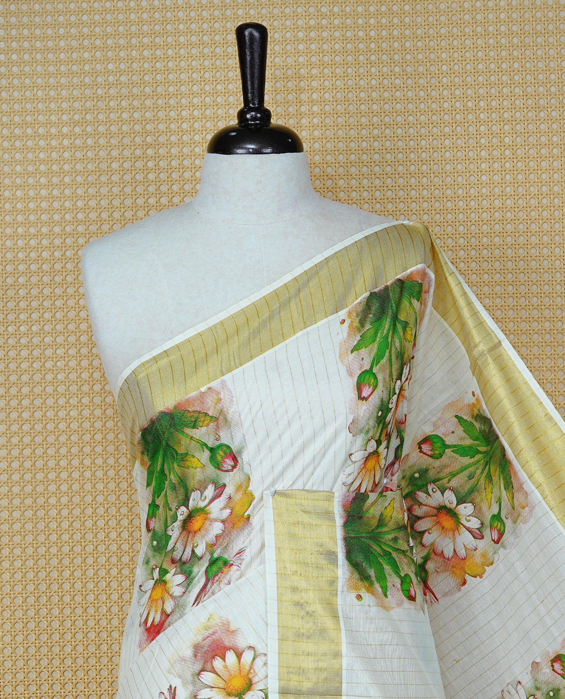 Cream Colour Kerala Saree Featuring Gold Zari Stripes On The Body, Enhanced By A Gold Zari Border With Floral Prints And A Matching Pallu, Paired With A Matching Blouse Piece.