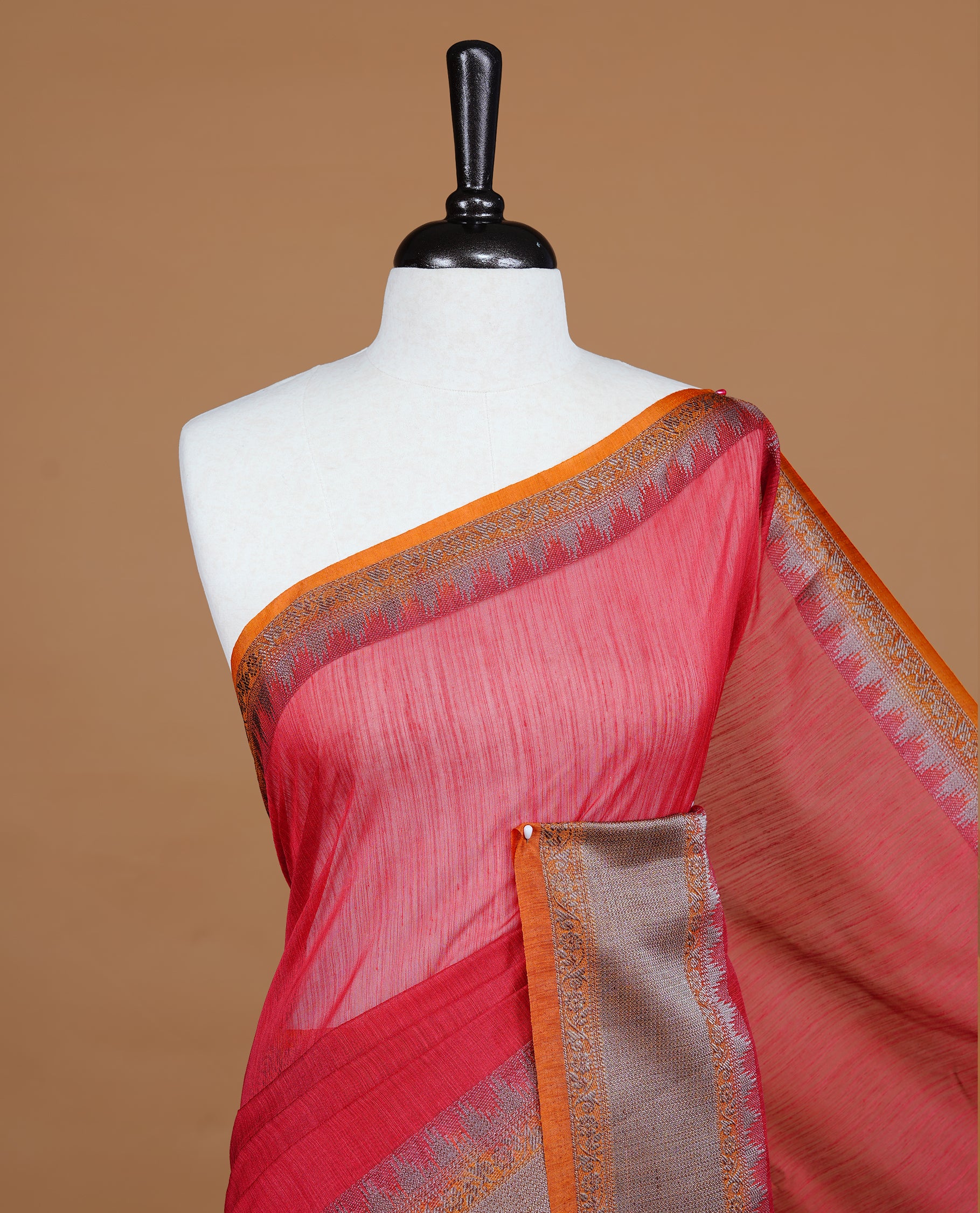 Red colour Semi linen saree featuring Elegant plain body, complemented by contrast Orange colour With Antique zari border, paired with matching blouse piece.