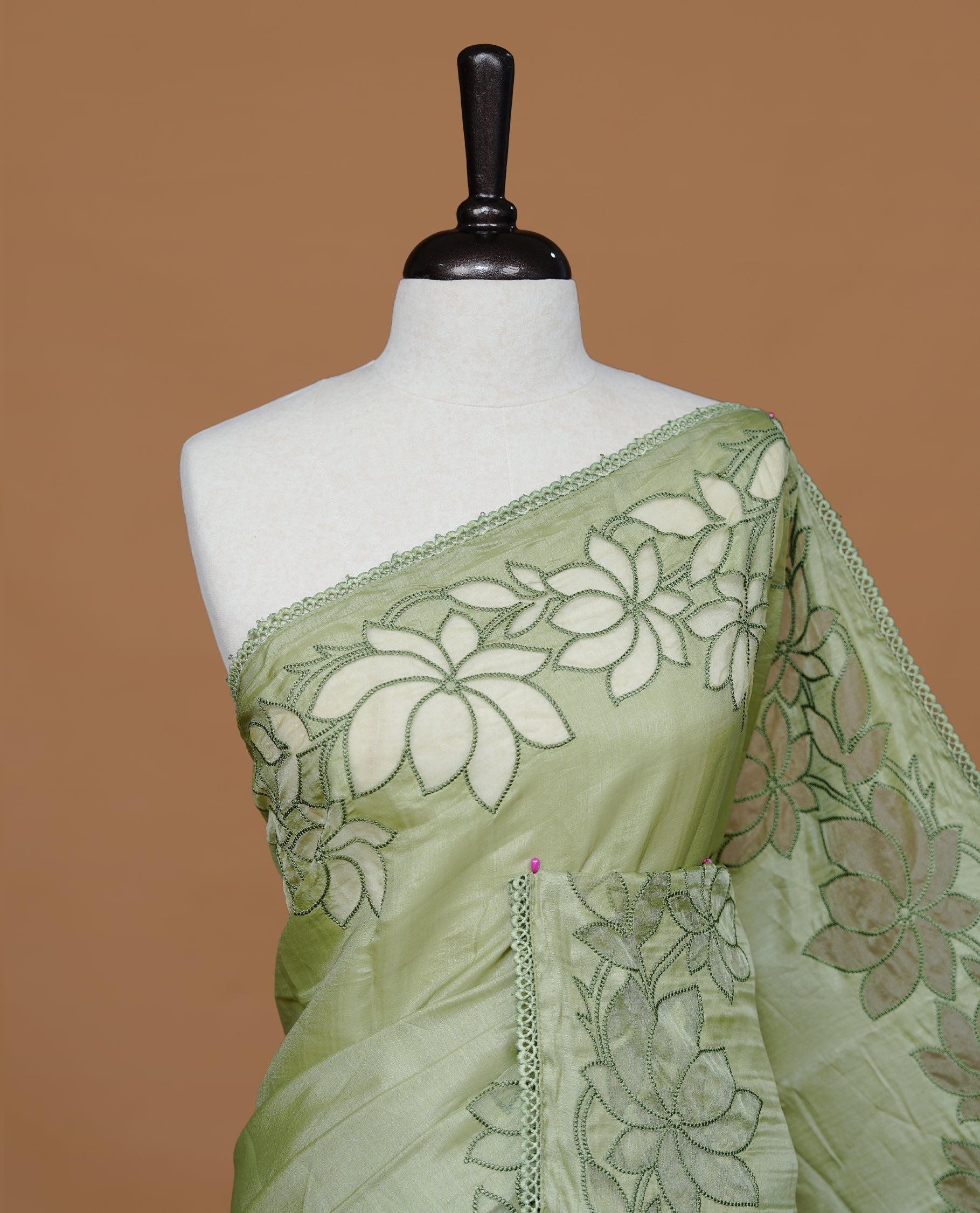 Pastel Green colour Designer saree Featuring Elegant plain body, enhance with thread Lotus Pattern with lace border, paired with matching blouse piece.