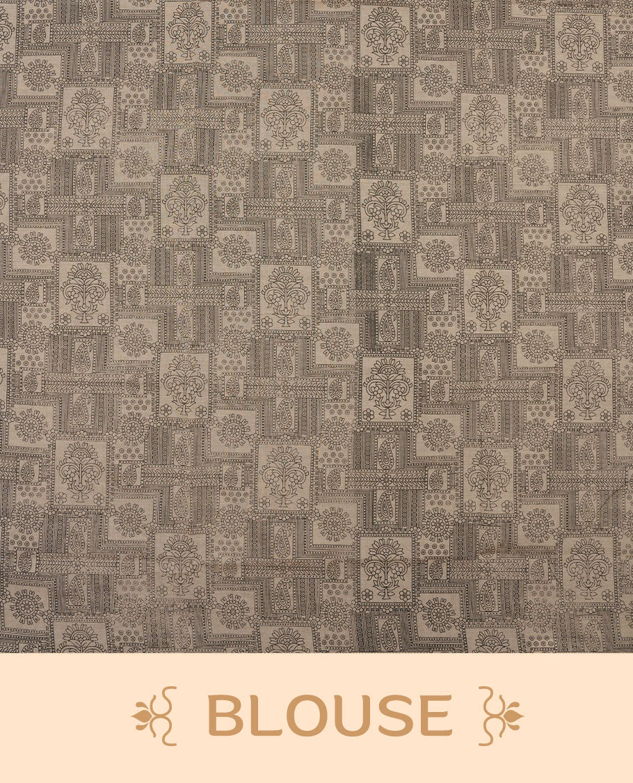 Dark Beige colour poly cotton saree with black zigzag line pattern on the body, paired with a matching pallu featuring black chevron lines and panelled floral‑paisley design, and a coordinated all‑over floral paisley patch‑style printed blouse piece.