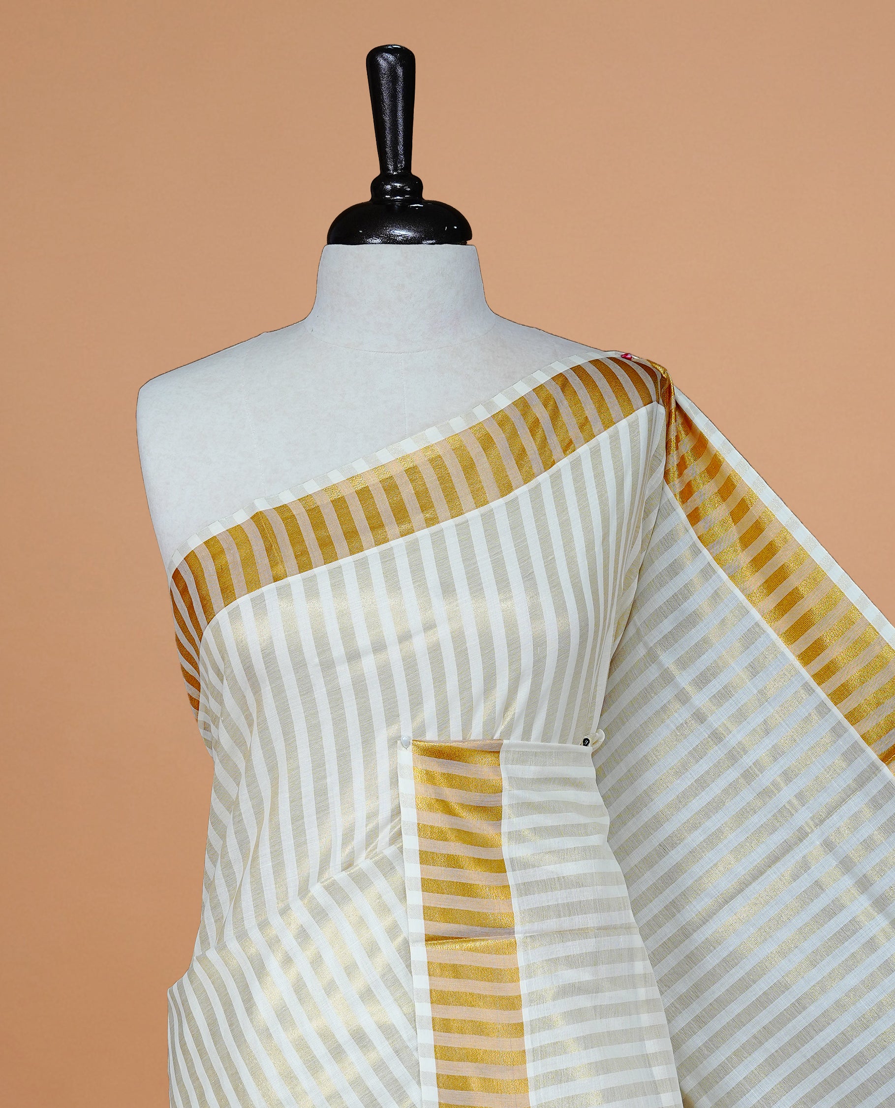 Cream colour Kerala saree featuring Gold zari Stripped body, enrich by Classy zari Border, pallu ,comes with matching blouse piece.