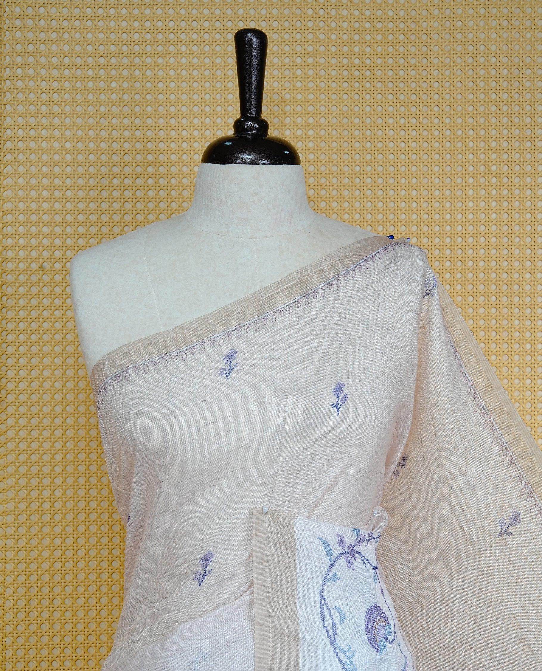 Beige colour semi linen saree featuring floral print on body, complemented by contrast Light gold colour with Design print border, comes with matching blouse piece.