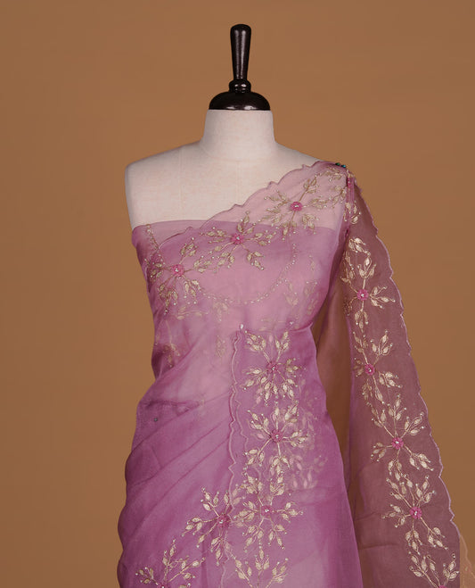Dusty Pink colour crush organza saree featuring gold thread floral and stone worked body, highlighting scalp designed border, paired with matching blouse piece.
