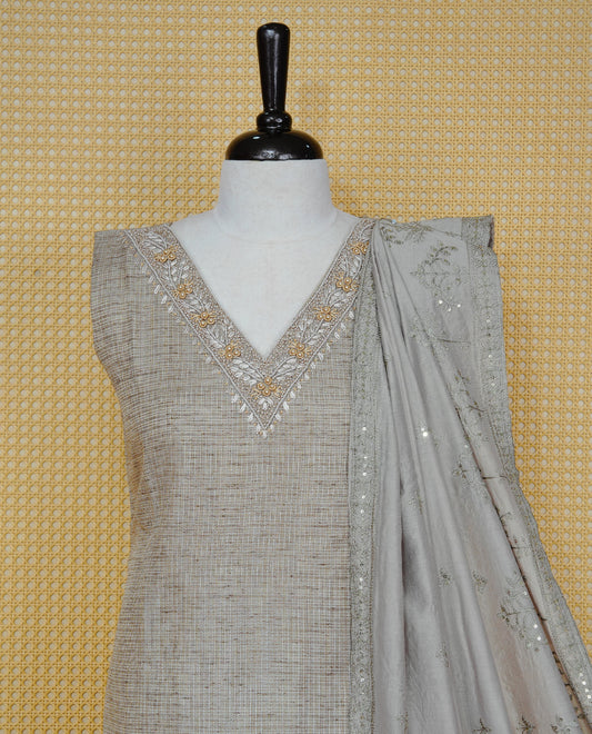Tan Beige colour Tissue Churidar Set featuring delicate embroidery and subtle bead detailing on the yoke, paired with matching solid pants and dupatta.