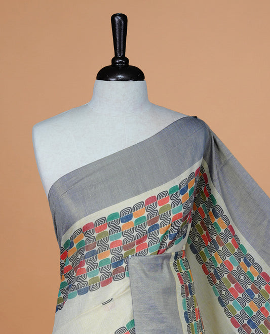 Cream colour Tissue kerala saree featuring Classy Multi colour Box pattern on body, Styled by blue & gold zari border and pallu, comes with matching blouse piece.