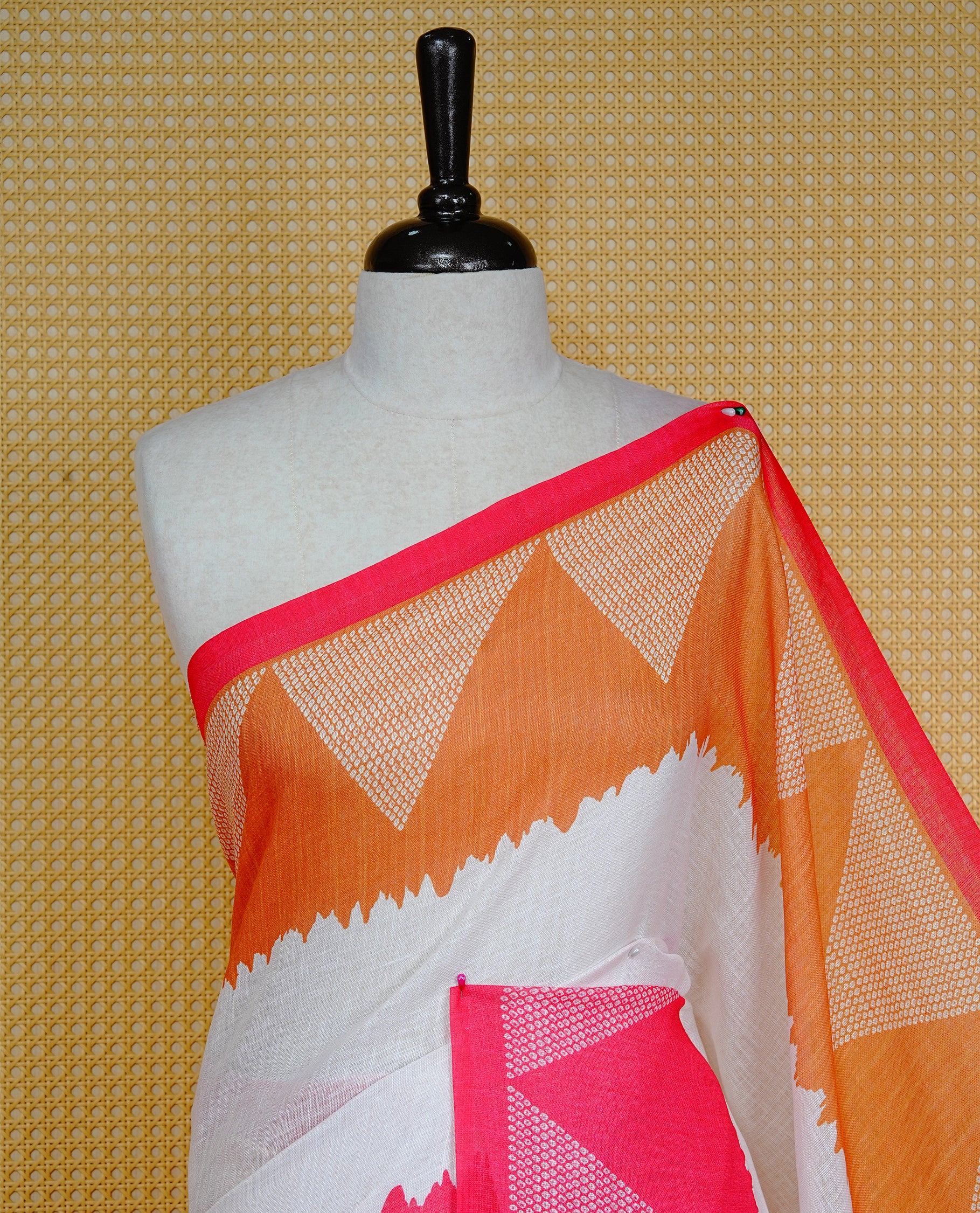 Cream colour semi linen saree featuring red Ajrakh pattern print on body, complemented by contrast Mustard colour with same pattern print Red border, comes with matching blouse piece.