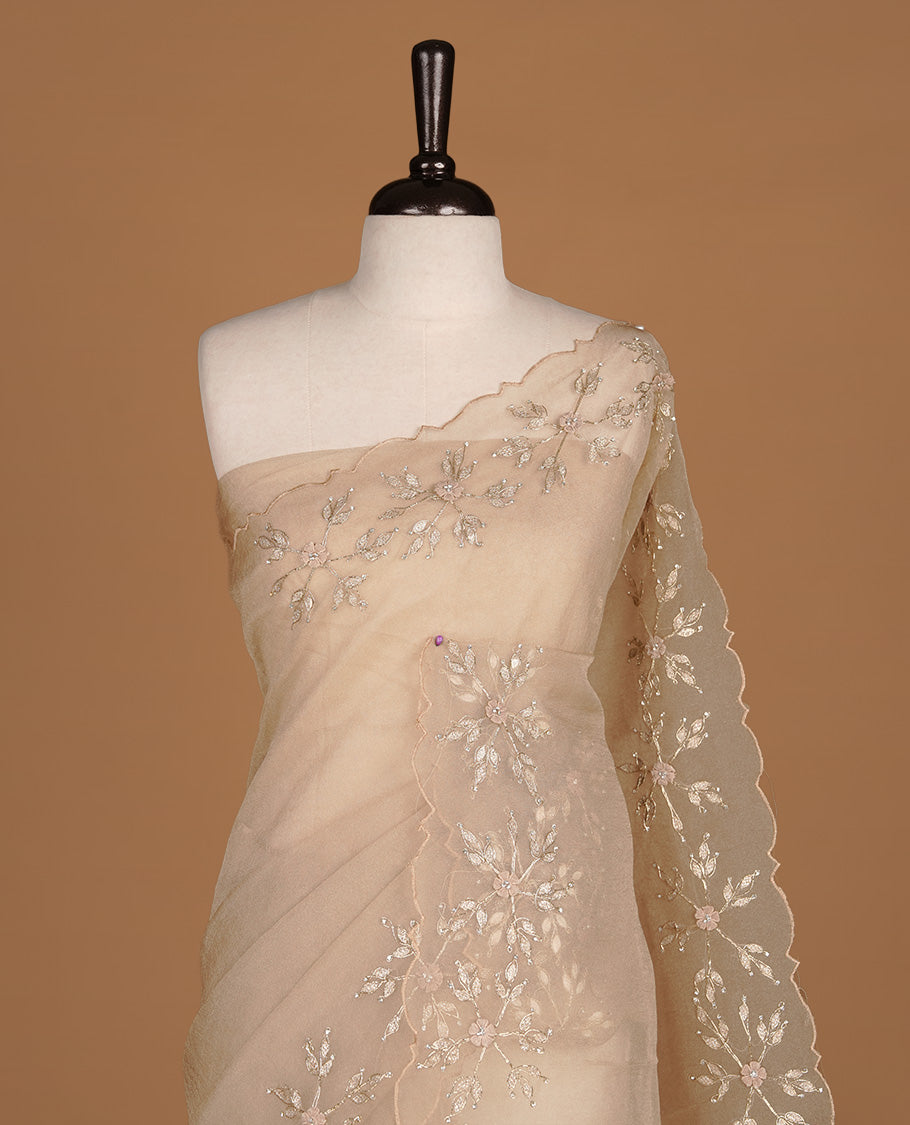 Light coffee colour crush organza saree featuring gold thread floral and stone worked  body, highlighting scalp designed border, paired with matching blouse piece.
