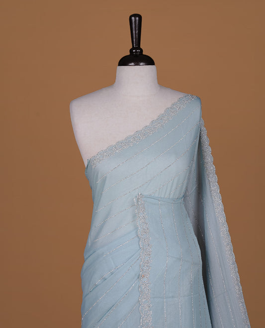 Mint colour designer saree featuring white stone stripes on body, highlighting white stone with scalp border, paired with matching blouse piece.