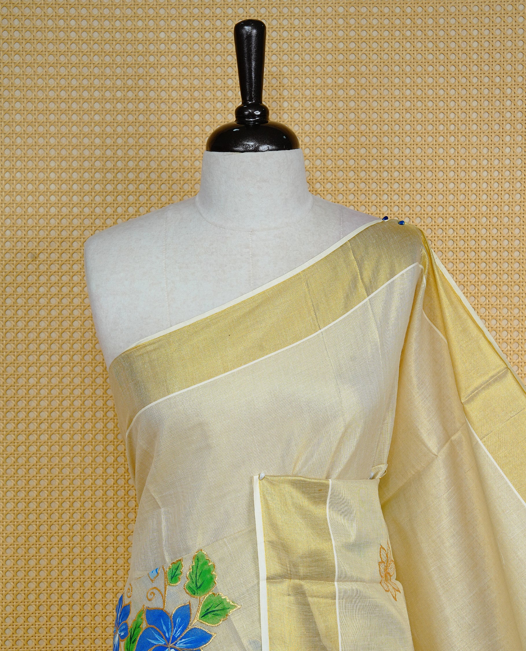 Cream colour Tissue kerala saree featuring Embroidery buttas on body, complemented by Floral thread work with Print & kasavu kara, comes with matching blouse piece.