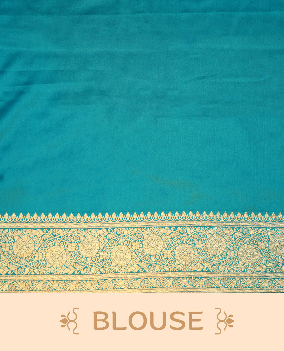 Teal blue colour Banaras Satin Crepe saree featuring gold zari floral motifs on the body, a richly woven traditional border with intricate gold zari detailing, and paired with a matching blouse.