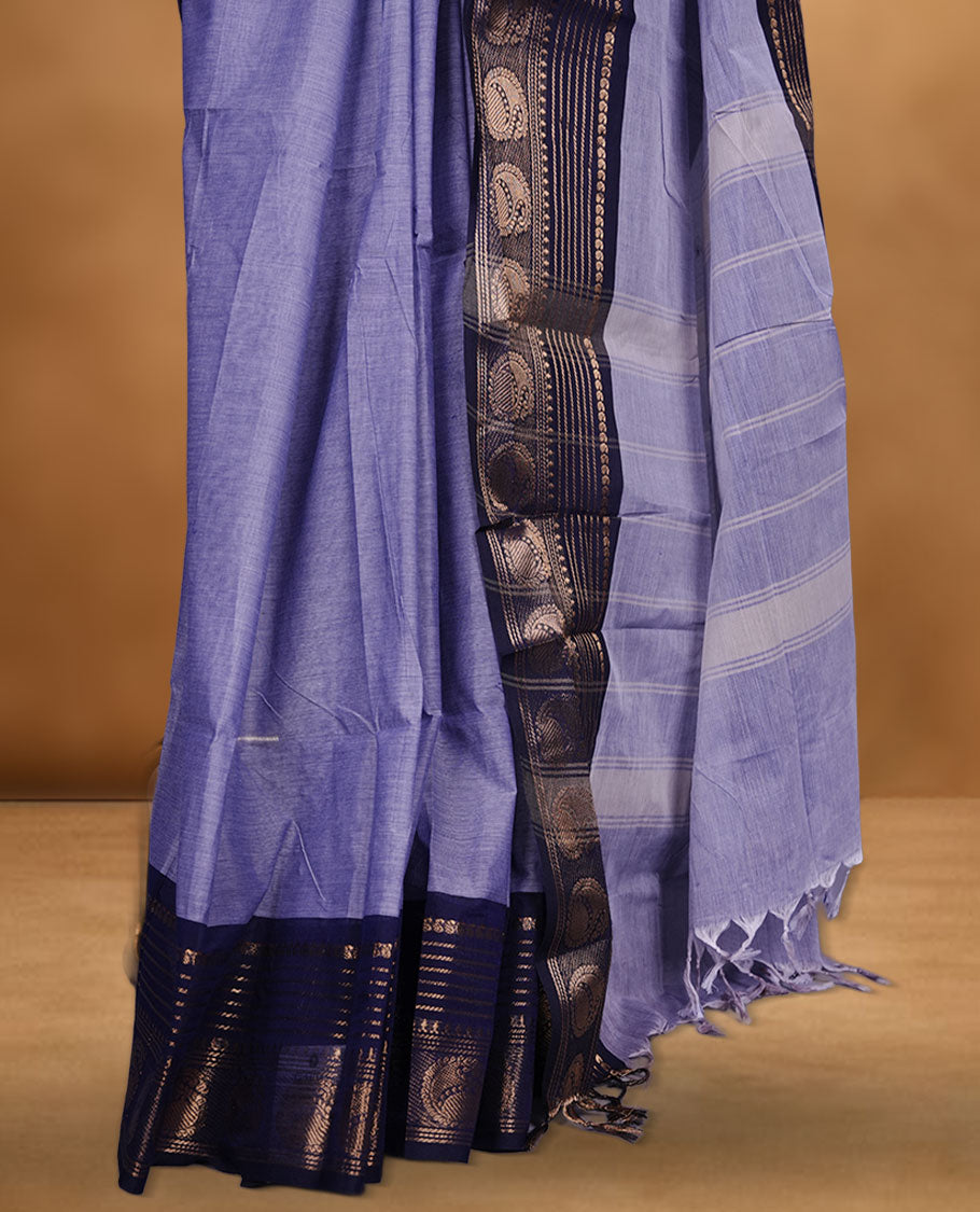 Lavender colour chettinad cotton saree featuring plain body, contrast Dark blue colour with traditional gold zari border paired with matching blouse.