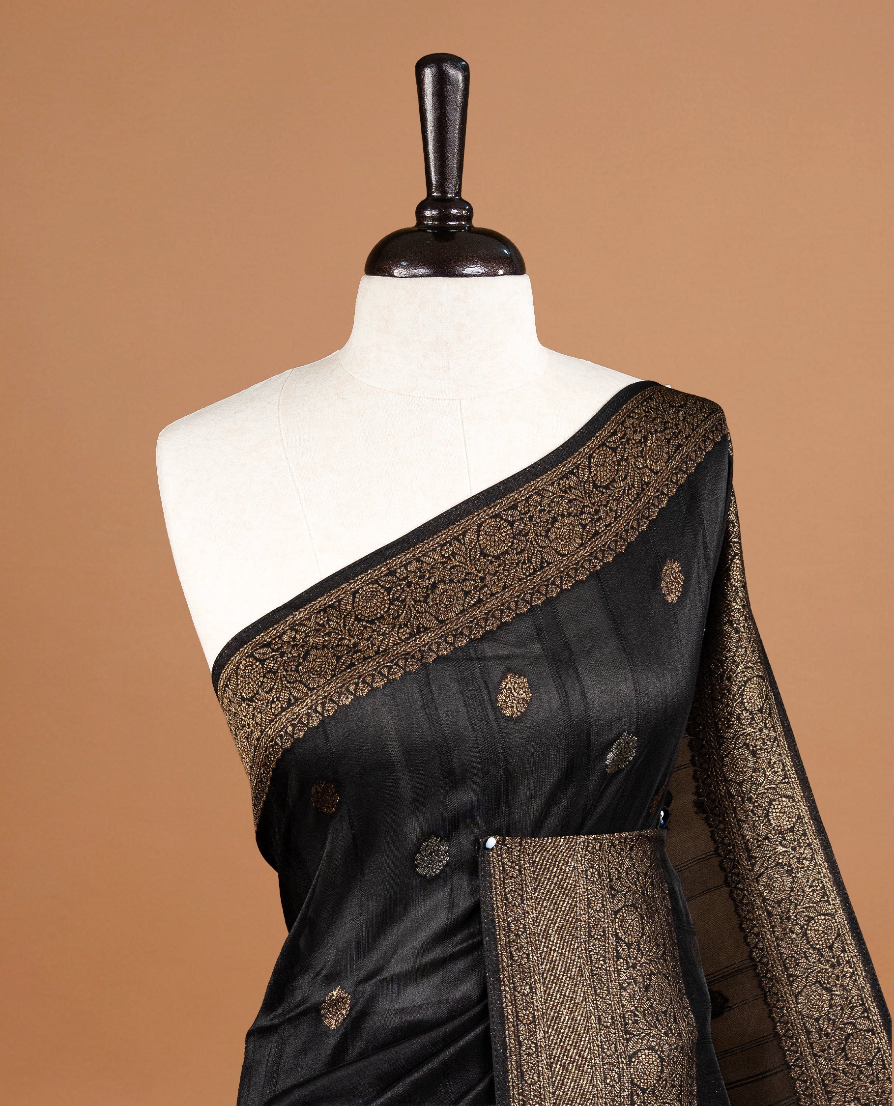 Black colour Semi banaras tussar georgette Saree featuring Antique zari motifs on body, enhanced with antique zari border, paired with a matching blouse piece.