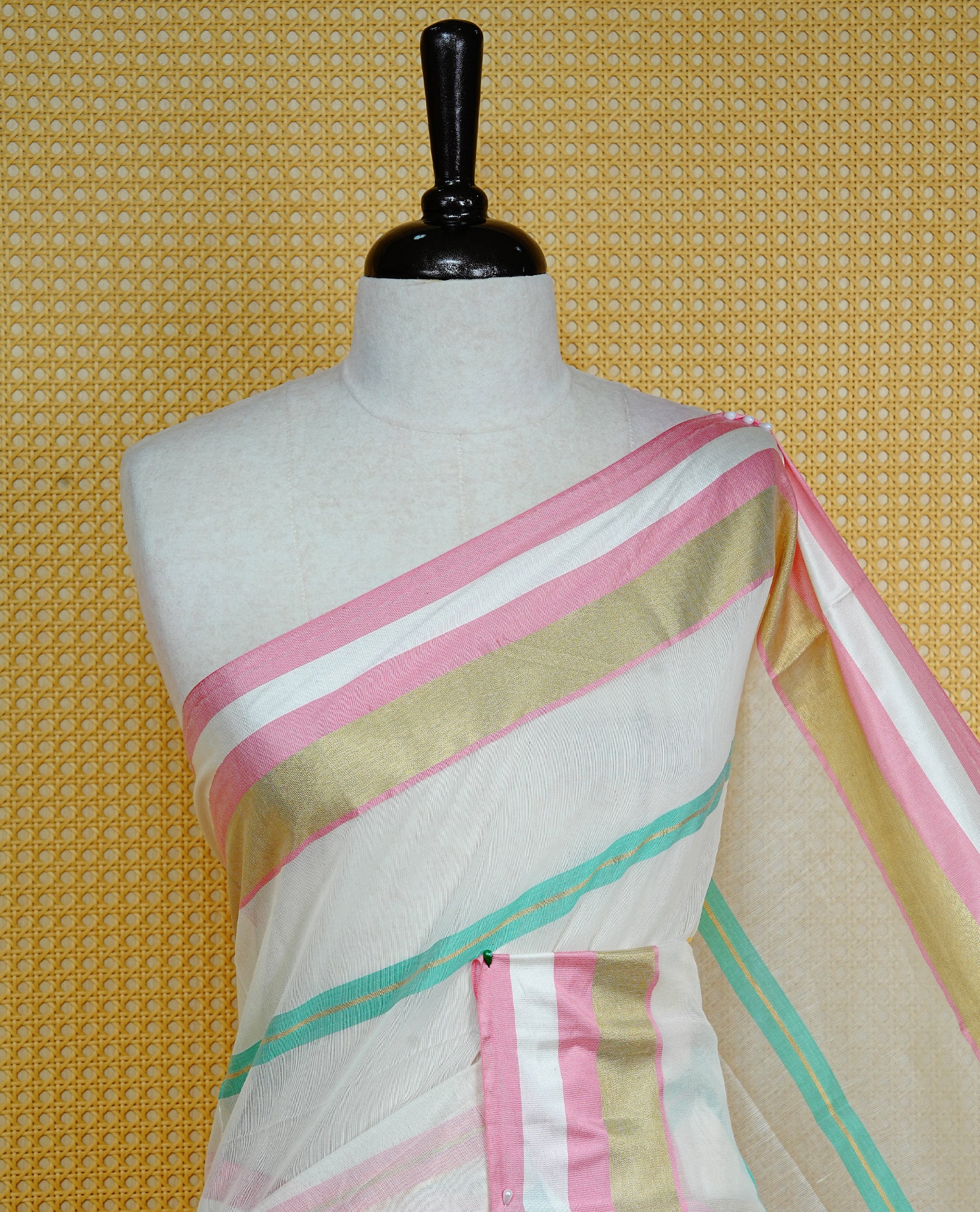 Cream colour Cotton kerala Saree featuring Pink, Gold zari and green colour striped body, Elegant borderless, comes with matching blouse piece.