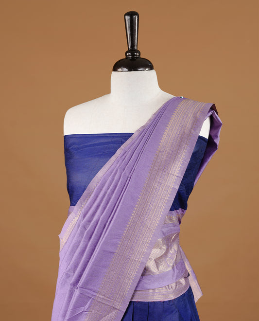 Navy blue colour semi stitched Half saree featuring contrast lavender colour with gold zari traditional border skirt, paired with matching zari border dupatta, unstitched blouse piece