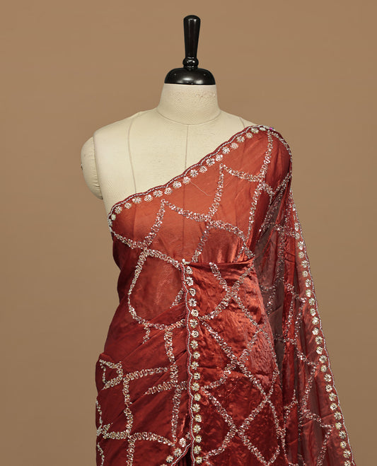 Brownish Orange colour designer saree featuring Sequins & cut beats worked body, cut beat worked border, paired with matching unstitched blouse.