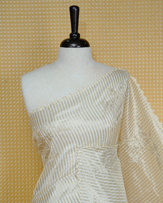 Cream colour Organza Saree featuring floral thread Work & Gold zari strip Design on body, Scallop border, comes with matching blouse piece.