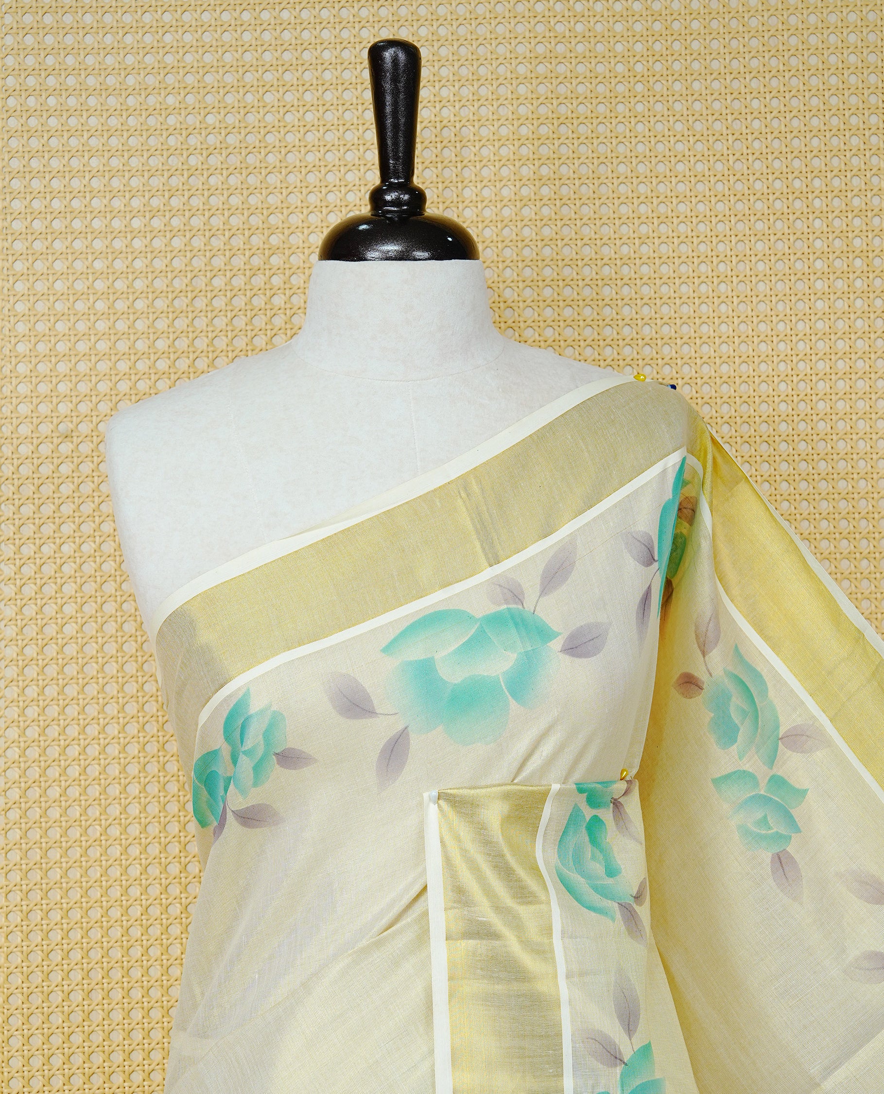Cream Colour Tissue Kerala Saree Featuring Digital  Mind Rose Prints Across The Body, Enhanced With A Gold Zari Border , Finished With Mind & Cream Tassels And A Matching Blouse Piece