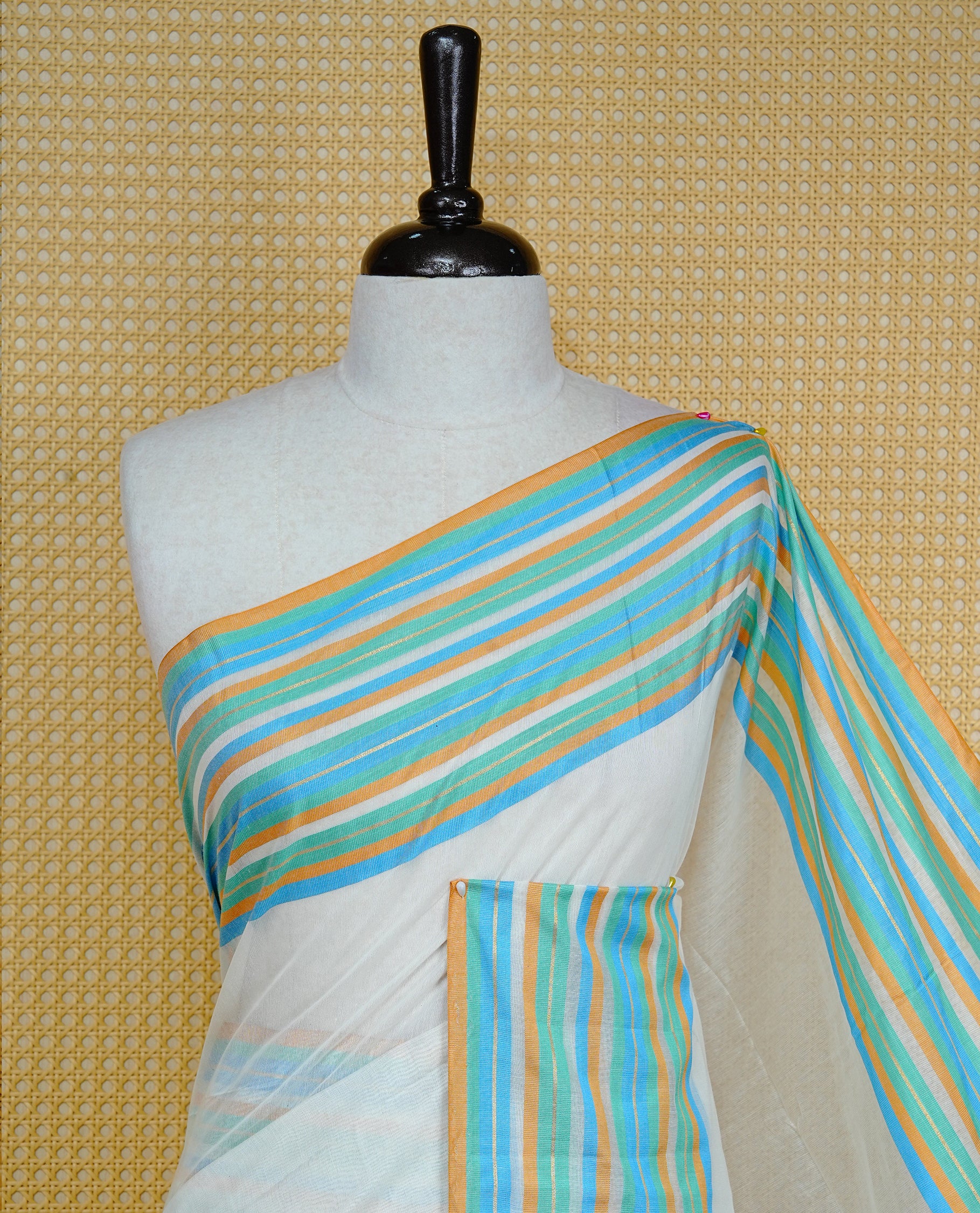 Off white colour semi linen saree featuring Elegant Plain body, complemented by contrast Blue, green Mustard colour with strip border, comes with matching blouse piece.