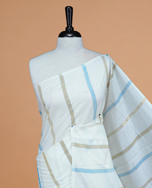 Cream Colour Cotton Kerala Saree Featuring Light Blue & Gold Zari Strips On The Body & Pallu, Paired With A Matching Blouse Piece.