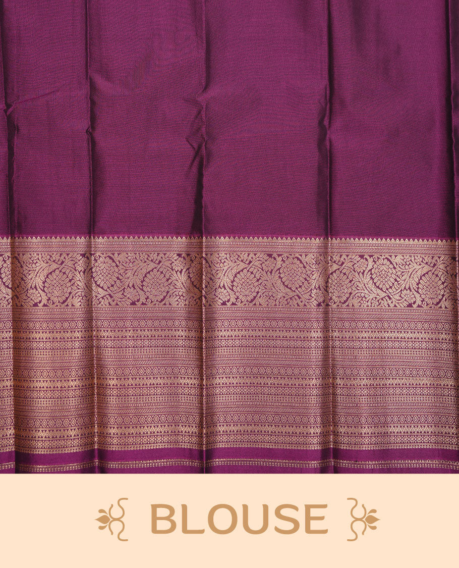 Green colour soft silk saree featuring Gold zari motifs on body, complemented by contrast purple colour with traditional border, paired with matching blouse piece.