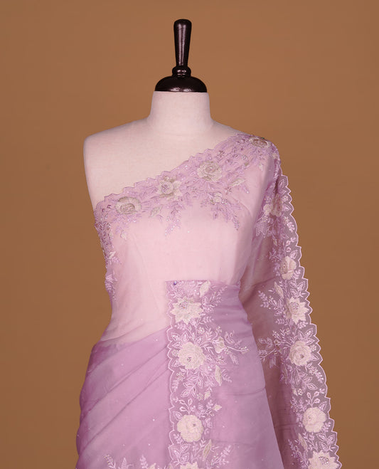 Pastel purple colour organza saree featuring thread with cut beats & sequins floral pattern on body, highlighting scalp border, paired with matching blouse piece.