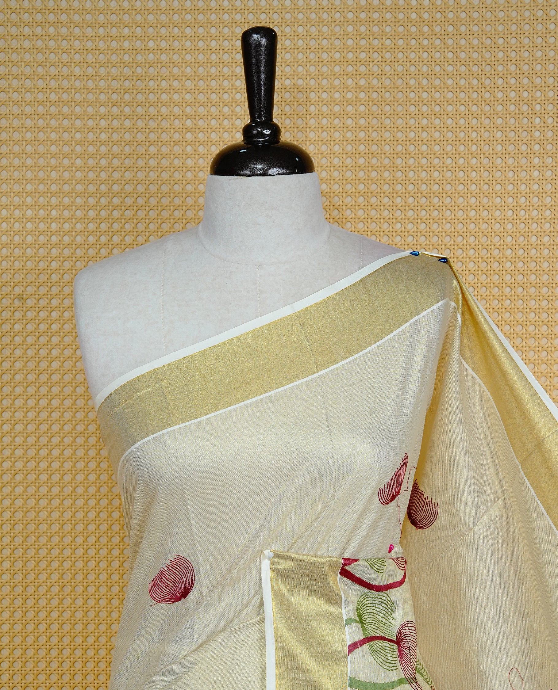 Cream colour Tissue kerala saree featuring Embroidery buttas on body, complemented by Plant thread work & kasavu kara, comes with matching blouse piece.