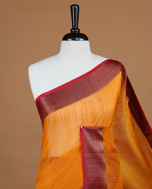 Mustard colour Semi linen saree featuring Elegant plain body, complemented by contrast Maroon colour With Antique zari border, paired with matching blouse piece.