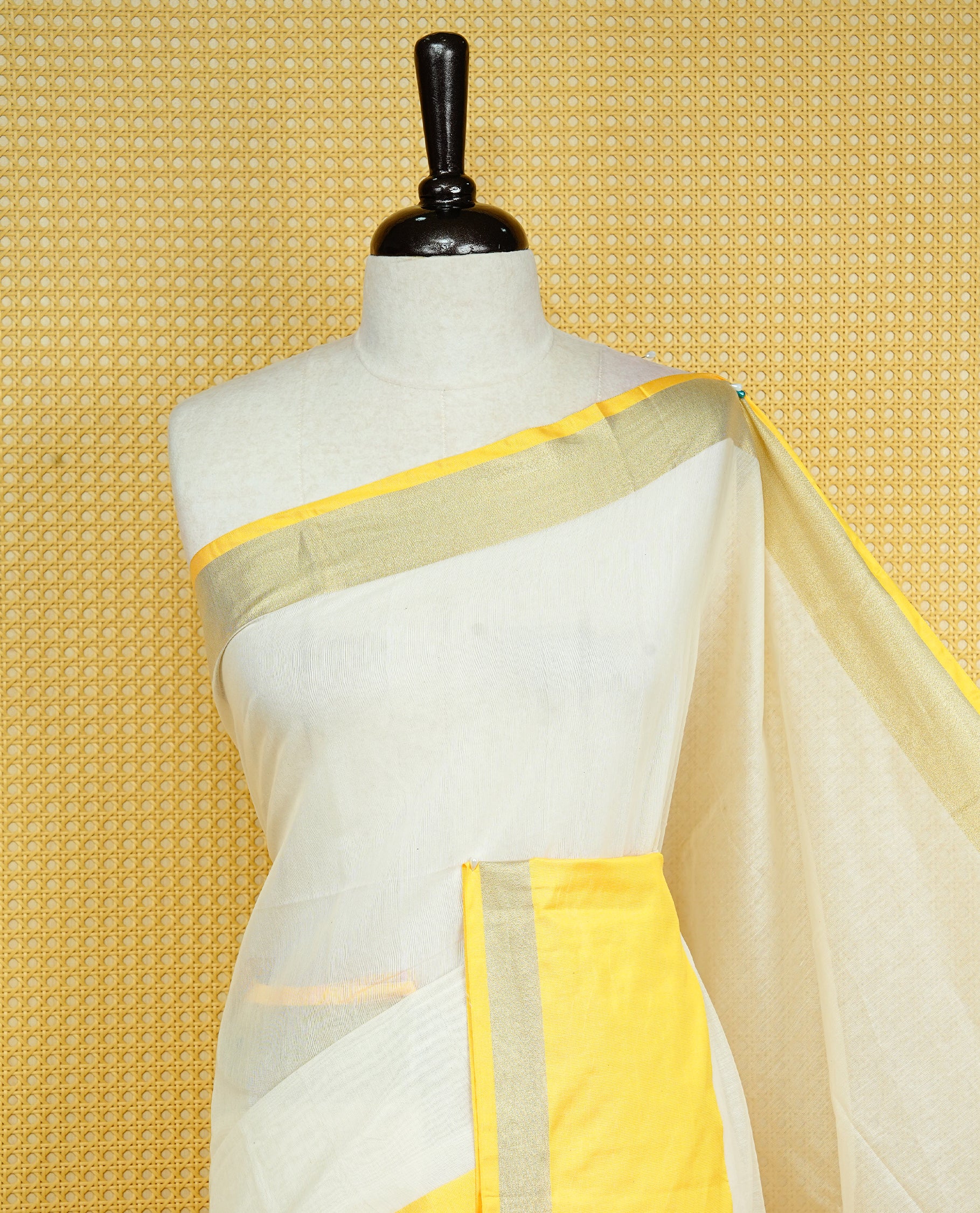 Cream colour Cotton kerala Saree featuring Plain body, Big yellow & gold kasavu border, comes with matching blouse piece.