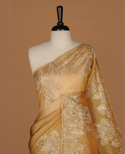 Gold colour organza saree featuring thread & cut beats, sequins leaf pattern on body, highlighting scalp border, paired with matching blouse piece.