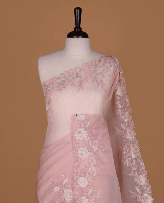 Pastel pink colour organza saree featuring thread with cut beats & sequins floral pattern on body, highlighting scalp border, paired with matching blouse piece.