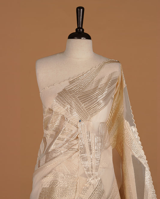 Cream colour pure net organza saree featuring gold geometric pattern on body, featuring scalp designed border, paired with matching blouse piece