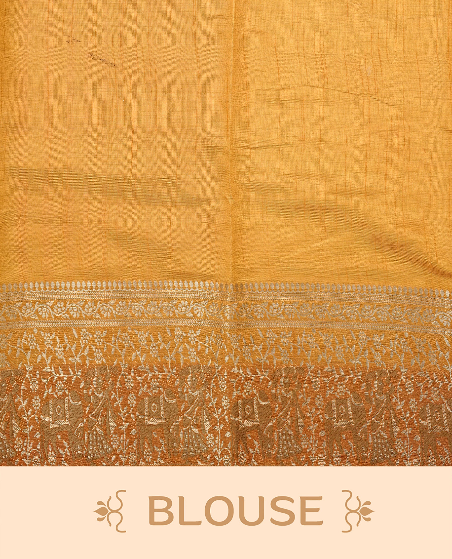 Light gold tussar saree featuring Elegant plain body, complemented by contrast Orange colour with Gold zari Floral kodi with Elephant Pattern border, comes with matching blouse piece.