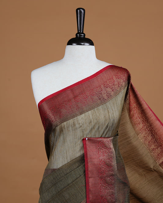 Bronze Olive colour Semi linen saree featuring Elegant plain body, complemented by contrast Green colour With Antique zari border, paired with matching blouse piece.