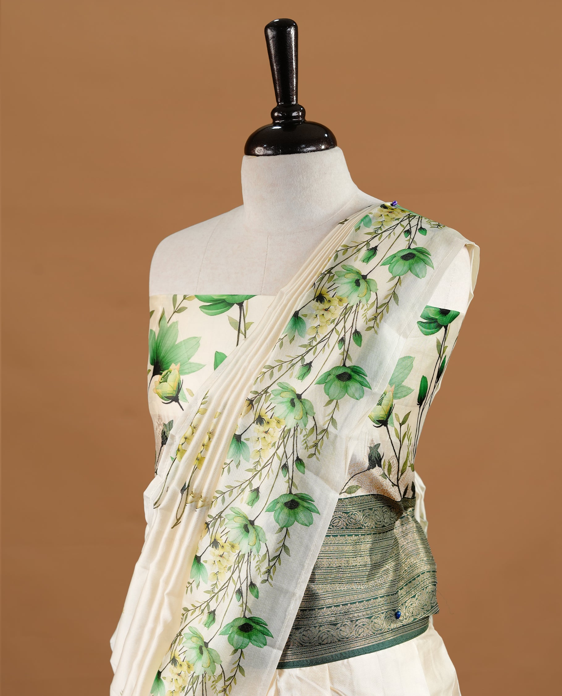 Off white colour semi stitched half saree featuring elegant Green colour floral prints, paired with a contrast green with traditonal zari border and matching printed dupatta ,paired with matching blouse piece.