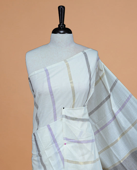 Off White Colour Cotton Kerala Saree Featuring Light Gold, Grey And Purple Zari Stripes On The Body, Enhanced By A Traditional Zari Border And Pallu, Paired With A Matching Blouse Piece.