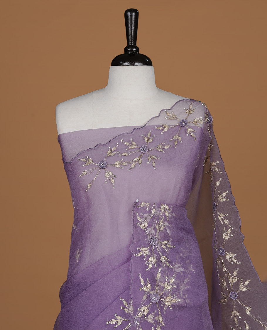 Pastel purple colour crush organza saree featuring gold thread floral and stone worked body, highlighting scalp designed border, paired with matching blouse piece.