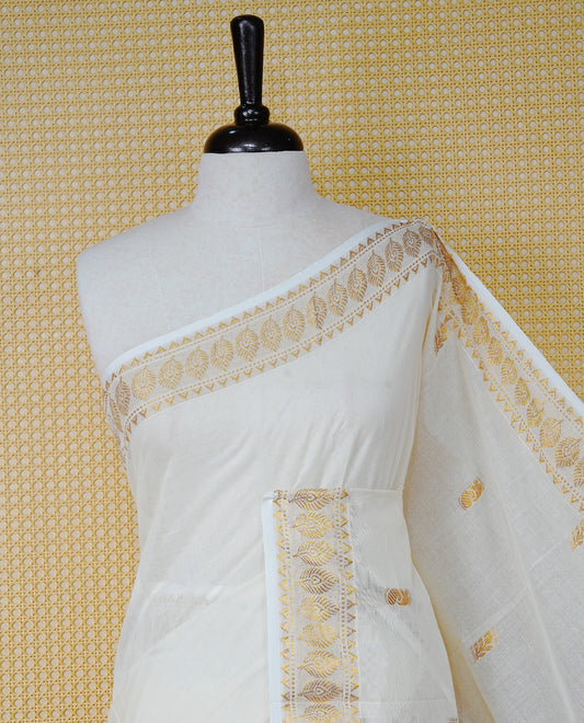 Cream Colour Cotton Kerala Saree Featuring Gold Buttas on the Body, a Classy Gold Zari Border, and a Traditional Black Colour Lord Krishna Thread work and Gold Zari Pallu, Paired with a Matching Blouse Piece.