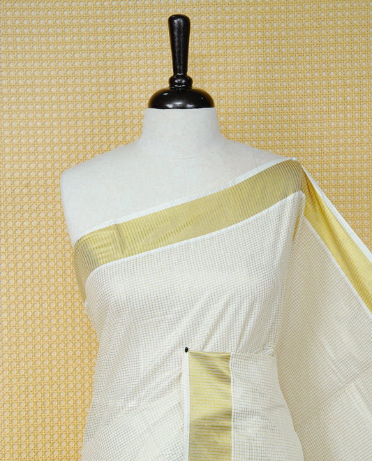 Cream Colour Cotton Kerala Saree Featuring A Golden Checks On Body, Enhanced With A Gold Zari  Border, A Traditional Gold Zari Pallu, And A Matching Blouse Piece.