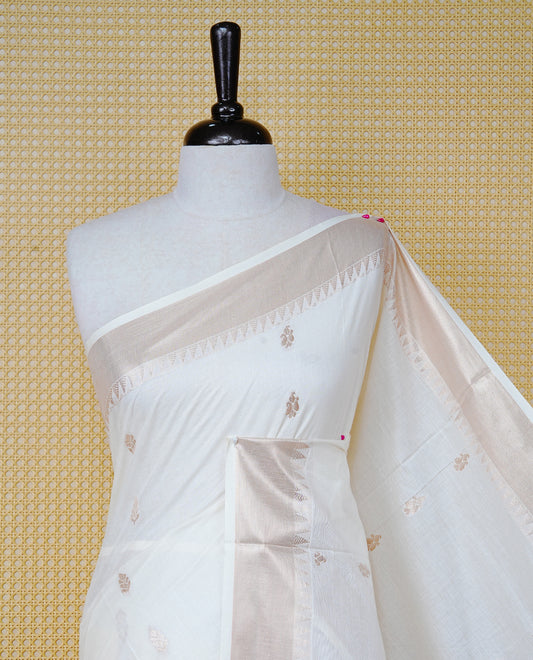 Cream Cotton Kerala Saree with  Gold Zari Leaf Motifs,  Gold Zari Leaf Pattern Border and Pallu, Paired with a Matching Blouse Piece.