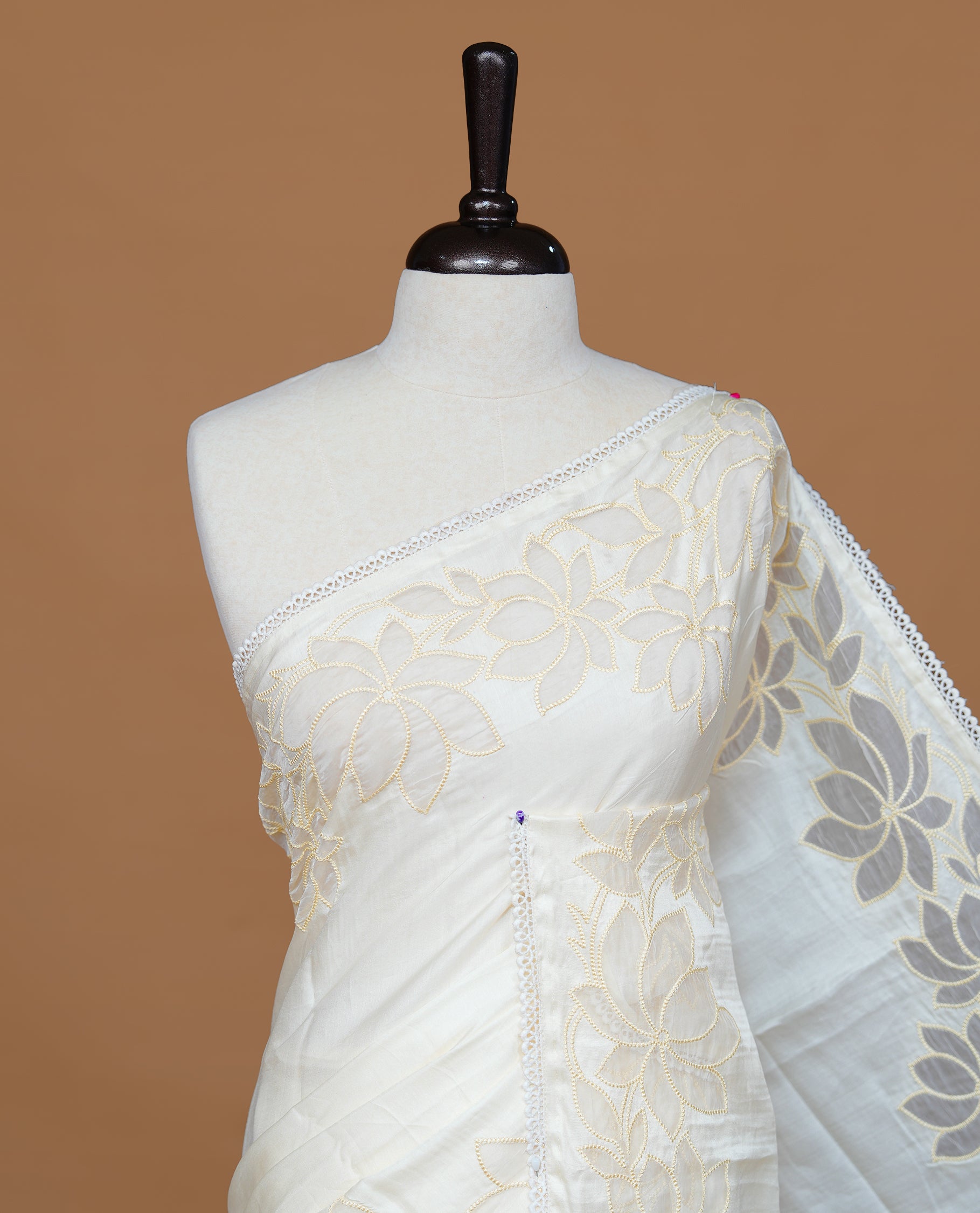 White colour Designer saree Featuring Elegant plain body, enhance with thread Lotus Pattern with lace border, paired with matching blouse piece.