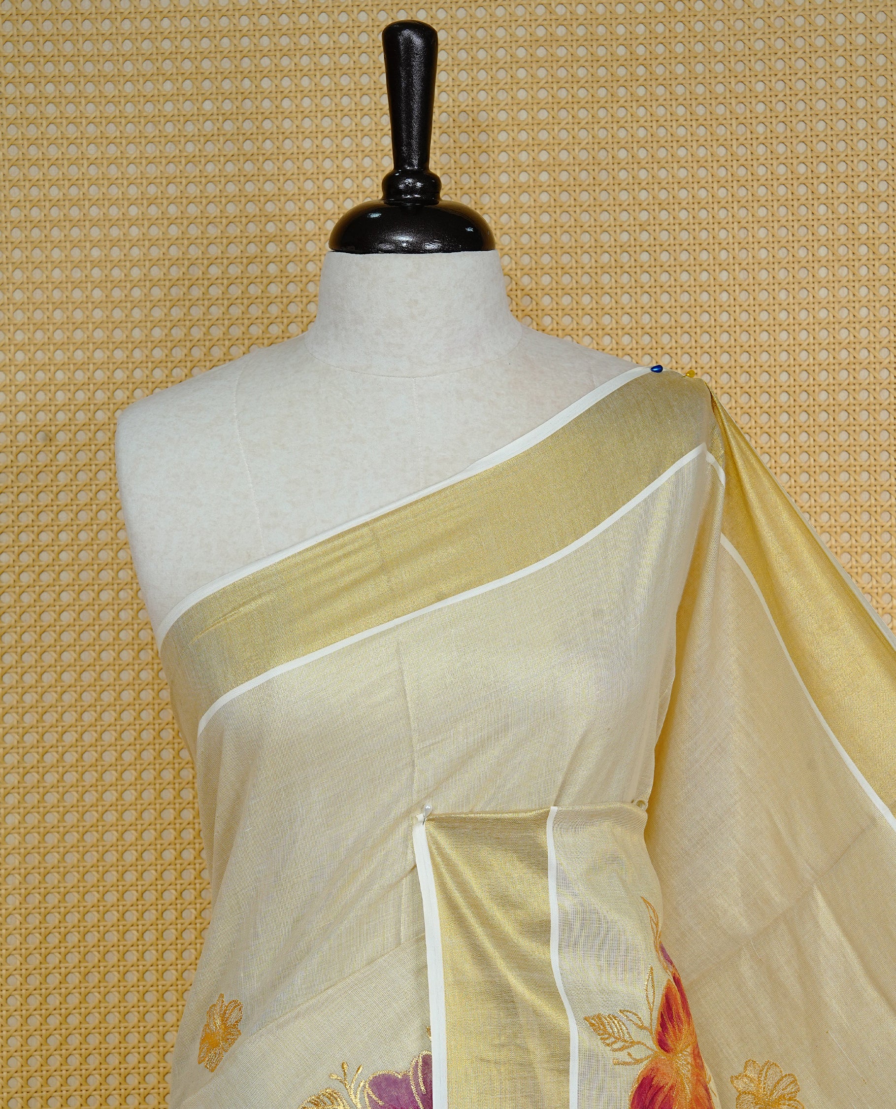 Cream colour Tissue kerala saree featuring Embroidery buttas on body, complemented by Floral thread work with Print & kasavu kara, comes with matching blouse piece.