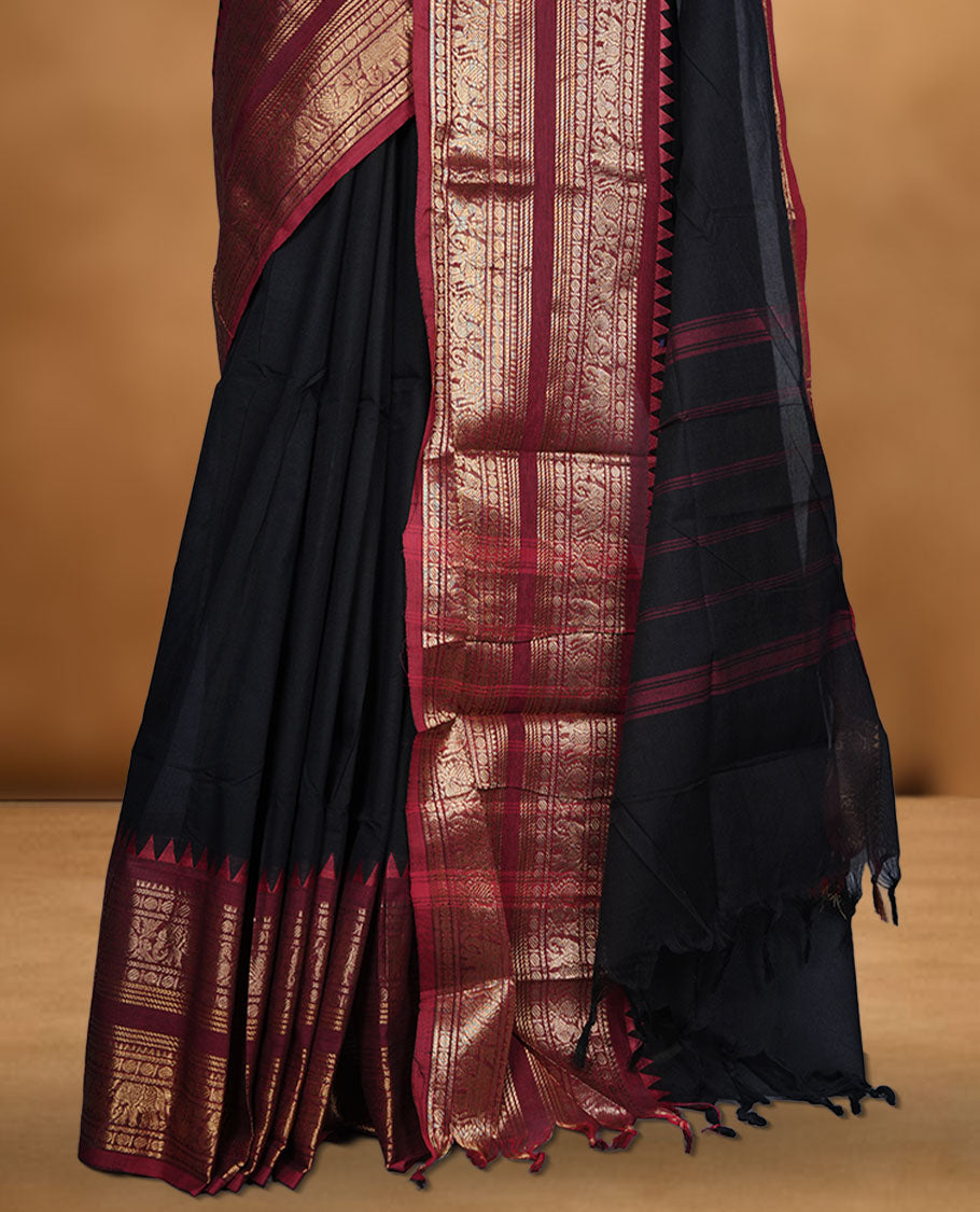 Black colour chettinad cotton saree featuring plain body, contrast maroon colour with traditional gold zari border paired with matching blouse.