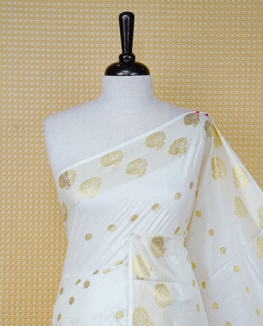 Cream Colour Cotton Kerala Saree Featuring Gold Zari Dot Motifs Across the Body, Enhanced with a Gold Zari Border and Traditional Gold Zari Pallu, Paired with Matching a Blouse Piece