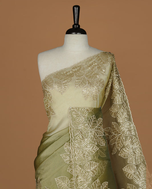 Green & gold double shade organza saree featuring thread & cut beats, sequins leaf pattern on body, highlighting scalp border, paired with matching blouse piece.
