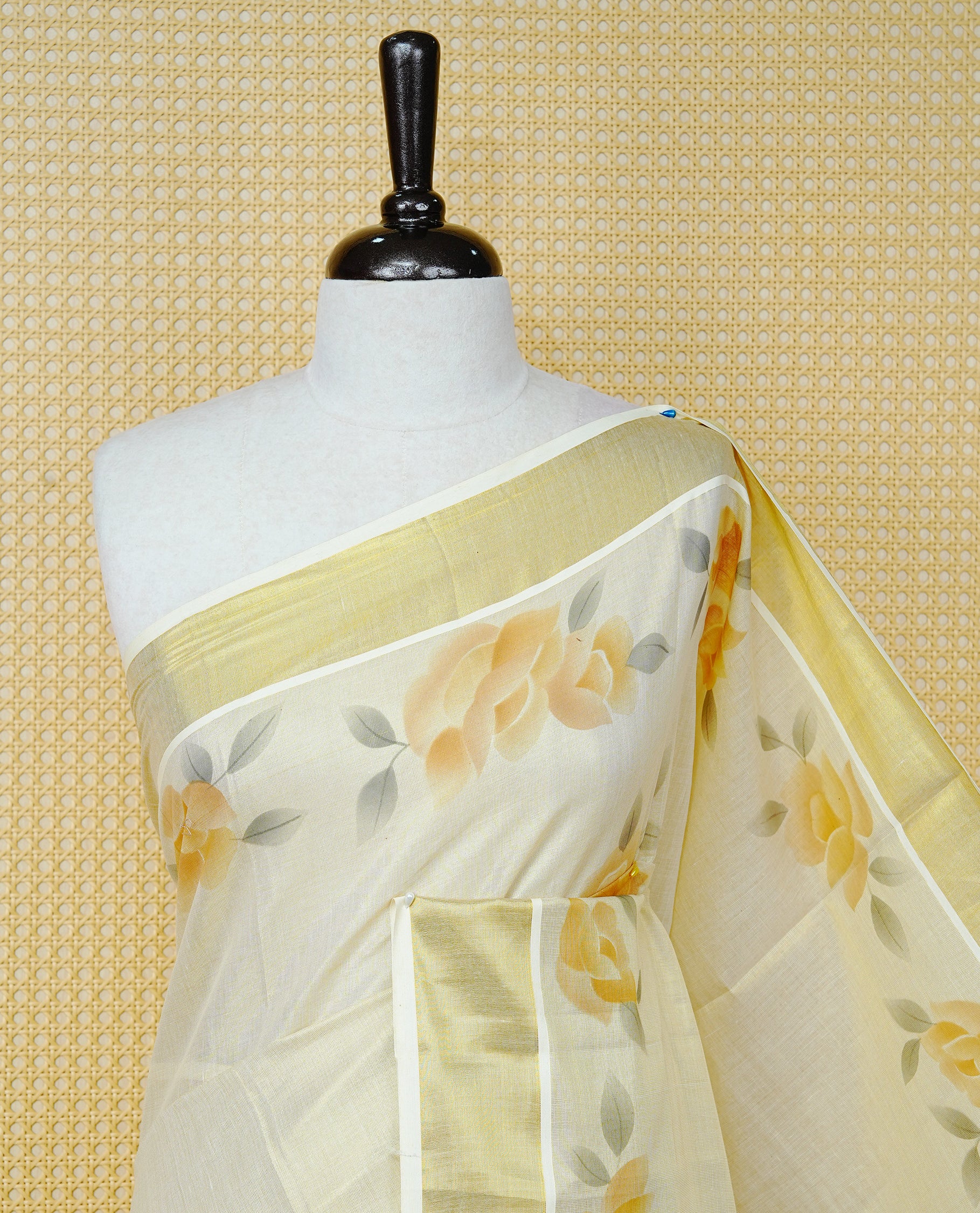 Cream Colour Tissue Kerala Saree Featuring Digital Mustard Yellow Rose Prints Across The Body, Enhanced With A Gold Zari Border , Finished With Light Brown & Cream Tassels And A Matching Blouse Piece