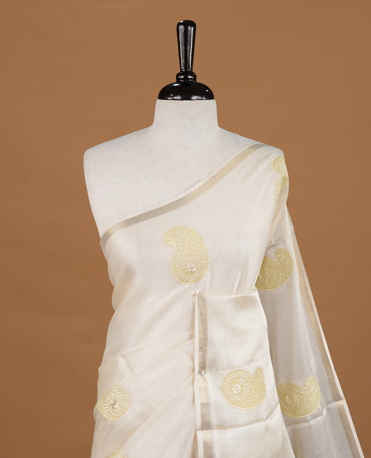 Cream colour Tussar saree featuring yellow colour Mango pattern with chikankari embroidery work, highlighting gold zari simple border, paired with matching unstitched blouse.