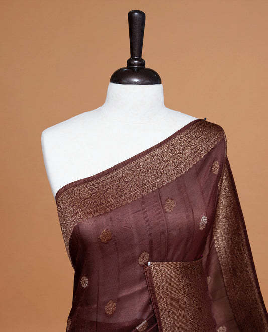 Chocolate brown colour Semi banaras tussar georgette Saree featuring Antique zari motifs on body, enhanced with antique zari border, paired with a matching blouse piece.